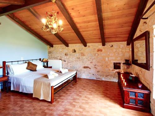 a bedroom with a bed and a chandelier at Chania's Diamond Villas - Aqua Bliss with Private Pools in Gavalochori
