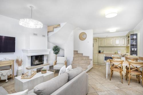 a living room with a couch and a fireplace at Aquilo Apartmanok in Tihany