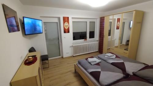 a bedroom with a bed and a television in it at Ferienhaus Kesper in Schottwien