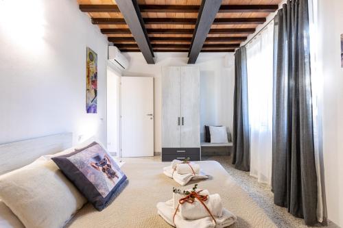 a living room with a bed and a large window at La Ripadoro Le Corti di Rivalto in Rivalto