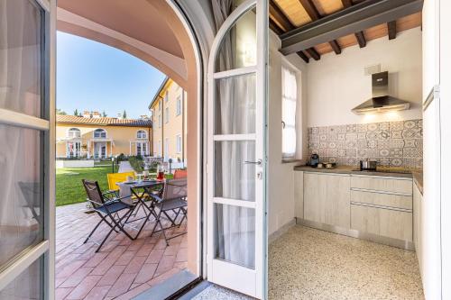 an open door to a patio with a table and a kitchen at La Ripadoro Le Corti di Rivalto in Rivalto