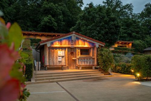 a small wooden cabin with a porch and stairs at Mondorf Parc Hotel & Spa in Mondorf-les-Bains