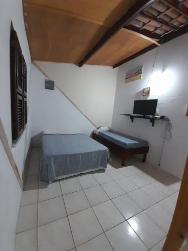 Ένα ή περισσότερα κρεβάτια σε δωμάτιο στο Vila Branca Canoa