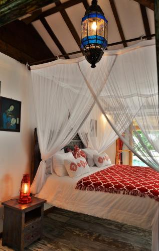 a bedroom with a bed with a canopy at Lata Lama in Lovina