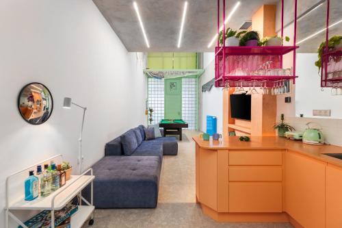 a living room with a couch and a table at Fabrica PlayLoft in the City Center by BiNoBi! in Thessaloniki