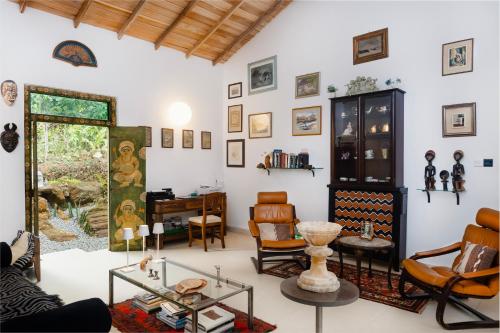 a living room with chairs and a table at Emel's Retreat By Tropical Magnum - Luxury Boutique Villa in Anhandigoda