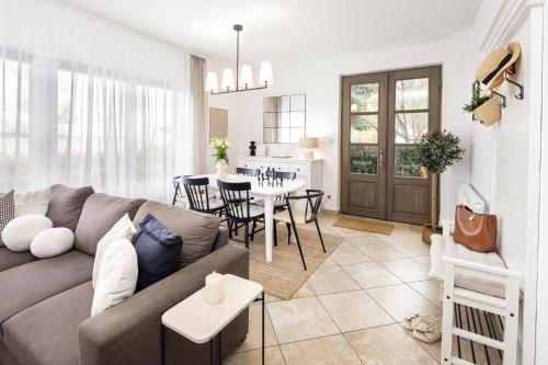a living room with a couch and a table at Aquilo Apartmanok in Tihany