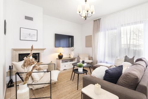 a living room with a couch and a fireplace at Aquilo Apartmanok in Tihany