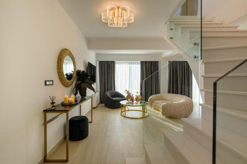 a living room with a staircase and a room with a couch at Cens Platinum Luxury Suites in Ioannina