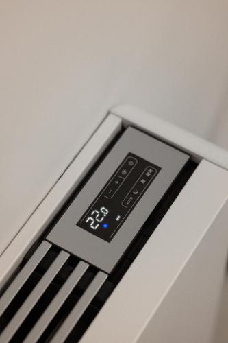 an alarm clock on top of a bed at Cens Platinum Luxury Suites in Ioannina