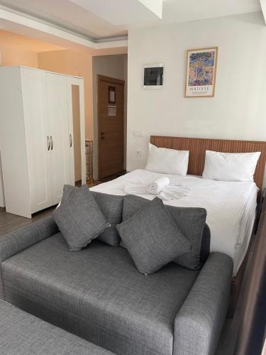 a bedroom with a bed with a couch in front of it at Sorta Hotel in Antalya