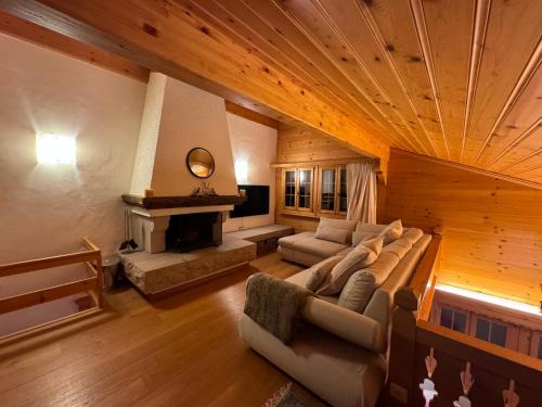 a large living room with a couch and a fireplace at Lovely 3 bedroom apartment in Schönried