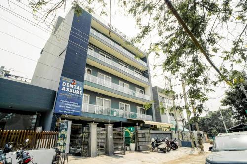 a building on a street with motorcycles parked in front of it at Saltstayz Express -Medicity Near Medanta Hospital in Gurgaon