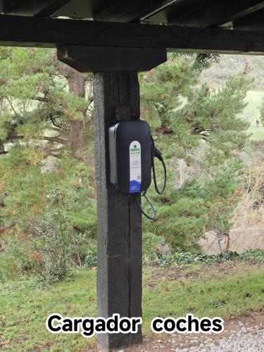 a soap dispenser on a wooden post with a view at El Nial de Los Pinos in Ojedo