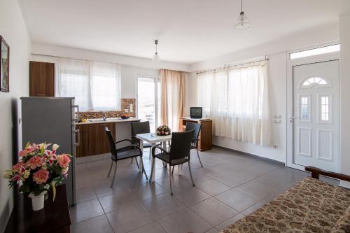 a kitchen and living room with a table and chairs at Faliraki Dream Studios & Apartments in Faliraki