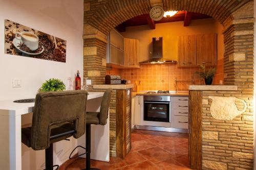 a kitchen with a brick wall at Studio Mateo in Rovinjsko Selo