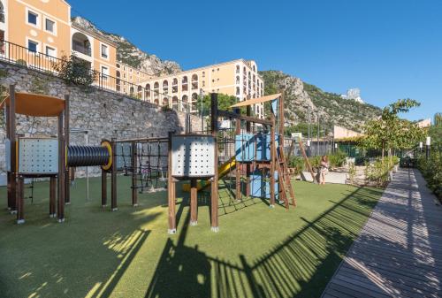 a park with a playground with a slide at MONACO Border LUXURY SUITE - SEA VIEW - POOL in Beausoleil