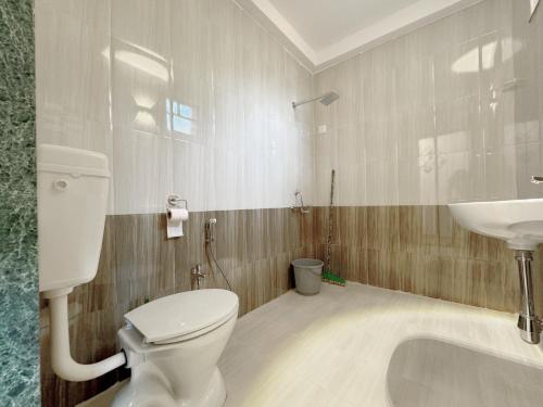 a bathroom with a toilet and a sink at Jack & Rose Stays in Orlim