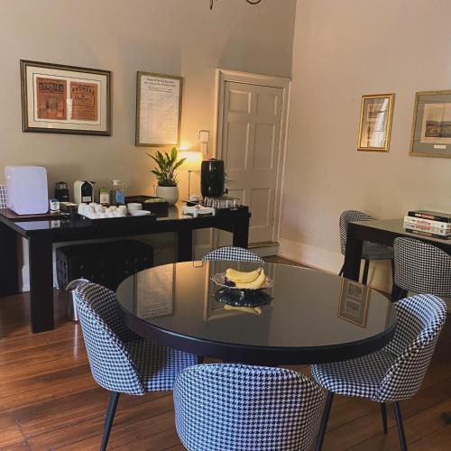 a table with a bowl of bananas on top of it at The Woodbridge Waterfront Rooms in New Norfolk