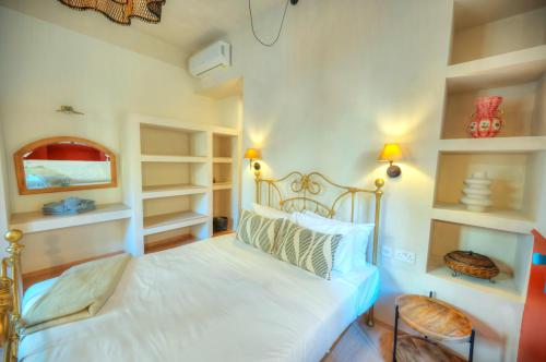 a bedroom with a bed with white walls and shelves at Luxury & stylish 4bedroom, Valletta centre LDEM1-1 in Valletta