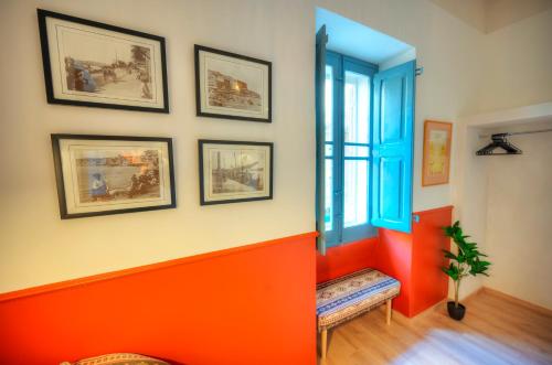 an orange and white room with a window and a bench at Luxury & stylish 4bedroom, Valletta centre LDEM1-1 in Valletta