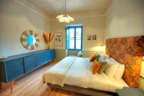 a bedroom with a large bed and a blue dresser at Luxury & stylish 4bedroom, Valletta centre LDEM1-1 in Valletta