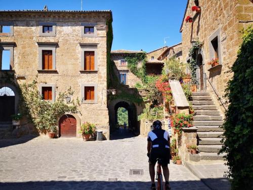a man riding a bike down a street at Agriturismo Buonasera in Bagnoregio