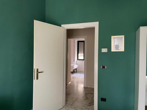 a room with green walls and an open door at B&B Boteroom in Cassino