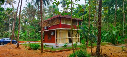 a small house in the middle of a forest at Makam Holiday Home in Iritti