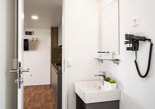 a bathroom with a sink and a mirror at Club del Sole Jesolo Family Resort in Lido di Jesolo