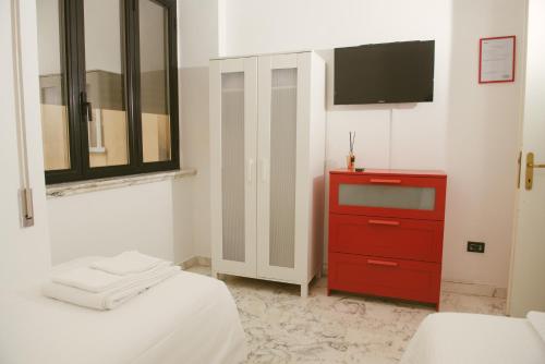 a bedroom with a red dresser and a tv at B&B Boteroom in Cassino