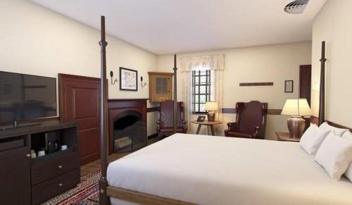 a bedroom with a large bed and a television at Colonial Houses, an official Colonial Williamsburg Hotel in Williamsburg