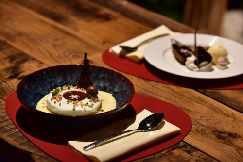 three plates of desserts on a wooden table at Mondorf Parc Hotel & Spa in Mondorf-les-Bains