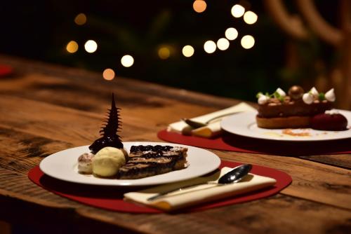 two plates of desserts on a wooden table at Mondorf Parc Hotel & Spa in Mondorf-les-Bains