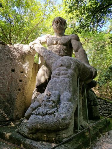a statue of a man sitting on top of a lion statue at Agriturismo Buonasera in Bagnoregio