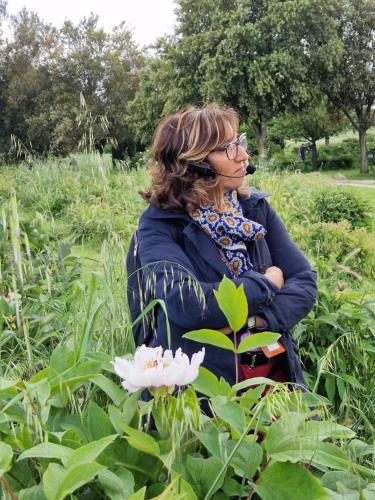 a woman standing in a field with a white flower at Agriturismo Buonasera in Bagnoregio