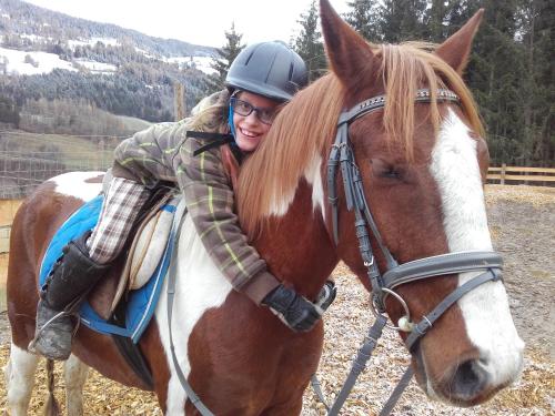 a man riding on the back of a brown and white horse at Apartment Krobath in Murau