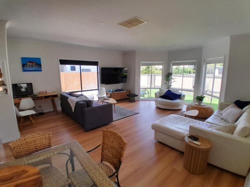 a living room with a couch and a table at Ocean Oasis Rosebud in Rosebud