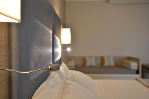 a hotel room with a bed and a lamp at Alma di Alghero Hotel in Alghero