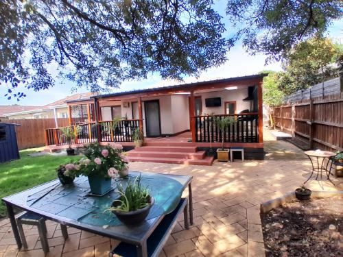 a patio with a table and a house at Ocean Oasis Rosebud in Rosebud