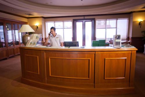 a man standing in front of a counter in a hotel room at Evergreen Laurel Hotel Penang in George Town