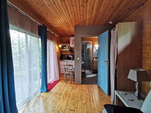 a living room with a hard wood floor and a ceiling at LA CHASSE ROYALE in Plailly