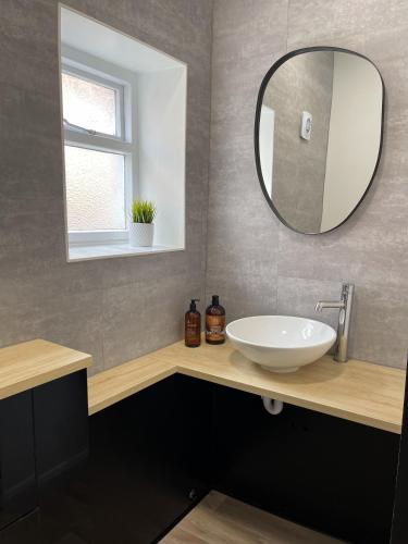a bathroom with a sink and a mirror at The Studio Apartment, Sleeps 4, Town Centre in Brampton