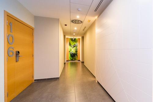 a corridor of an office building with a door at Vistamar Hotel Luxury Wellness By DLV -Adults Only- in Villajoyosa