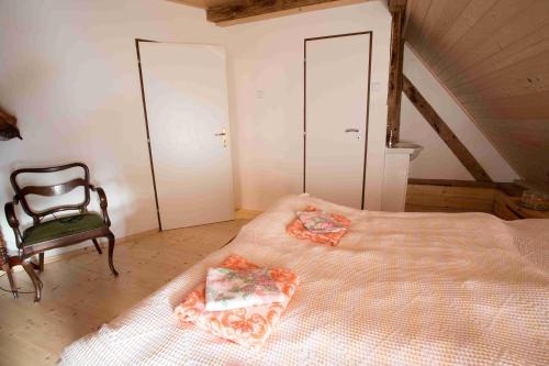 a bedroom with a large bed and a chair at Zamek Usobi in Úsobí