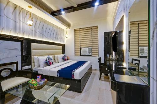 a hotel room with a bed and a desk at Hotel Baba Deluxe near New Delhi Railway Station and City Center -By RCG Hotels in New Delhi