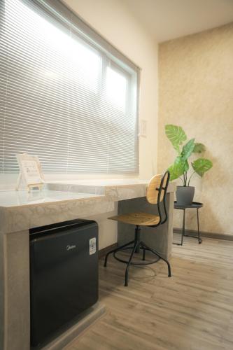 a kitchen with a sink and a desk and a window at Suites Only KKB in Kuala Kubu Baharu