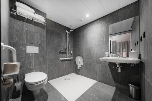 a bathroom with a toilet and a sink at GREEN PARK HOTEL PARIS in Paris