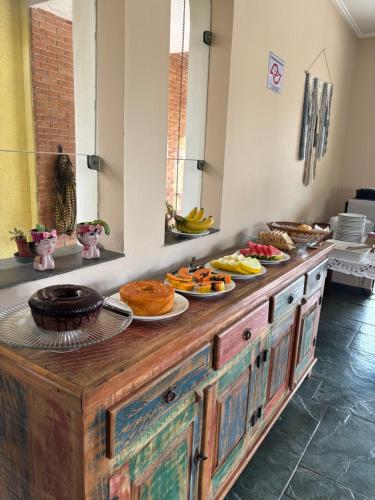 a buffet with plates of food on top of it at Pousada As Ondas in Guarujá