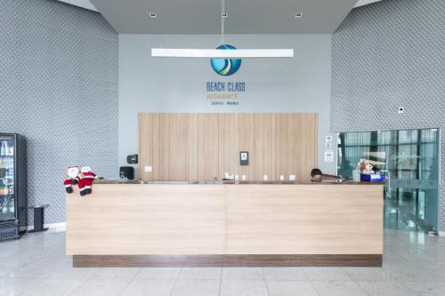 a lobby with a reception desk in a store at Beach Class Santa Maria by Easy Home in Recife